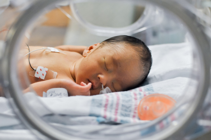 Photo shows newborn baby in incubator