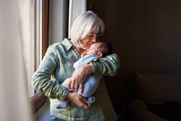 Photo shows older woman holding baby