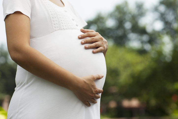 Photo shows a pregnant woman holding her stomach/Getty Images
