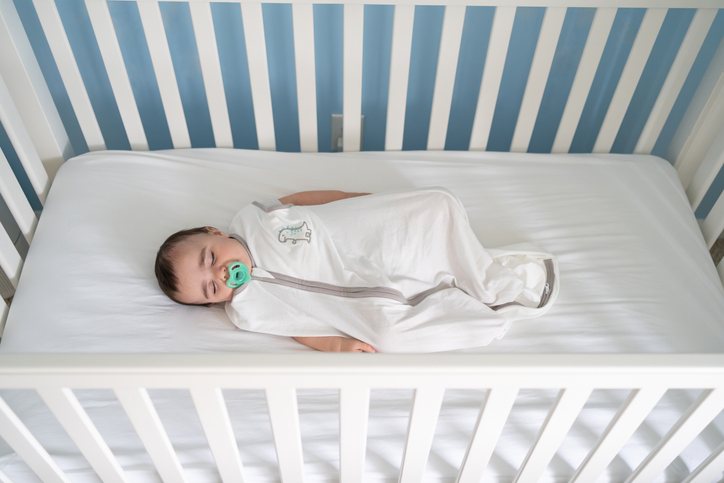 Photo shows a baby sleeping in a safe crib/Getty Images