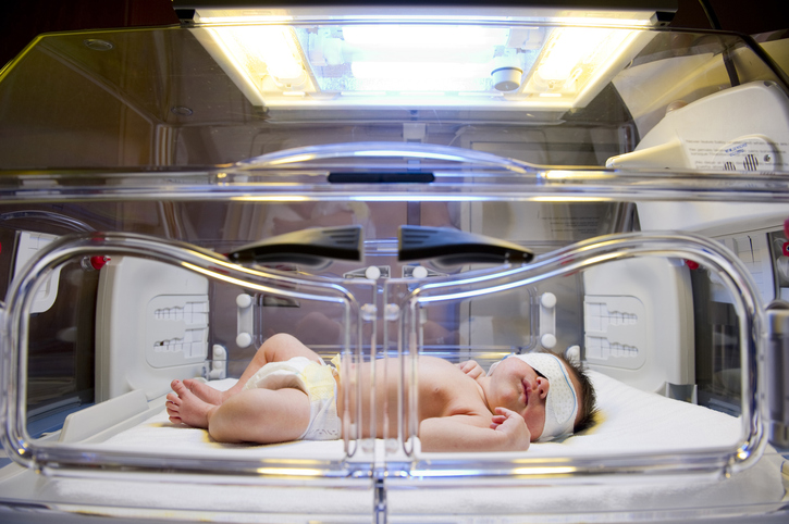 Photo shows newborn under the lights in an incubator wearing eye shields/Getty Images