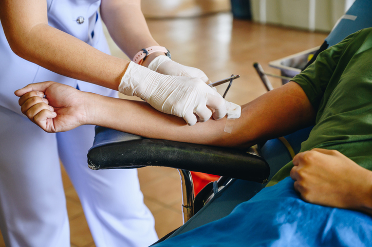 Photo shows a nurse wiping a blood donor's arm/Getty Images