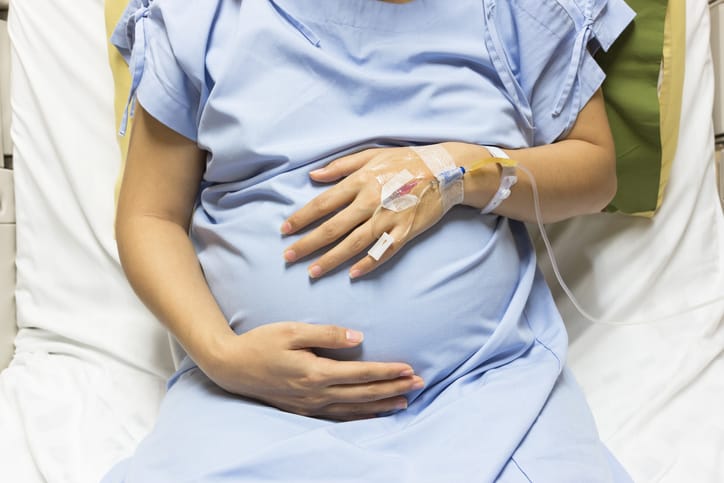 Photo shows a pregnant woman receiving an IV/Getty Images